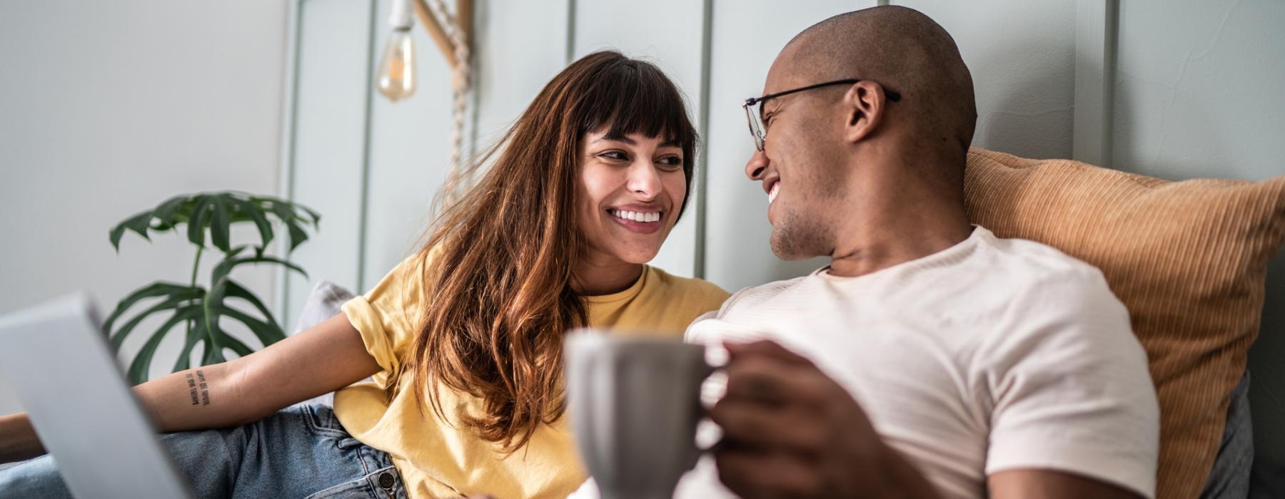 a man and a woman looking at a laptop